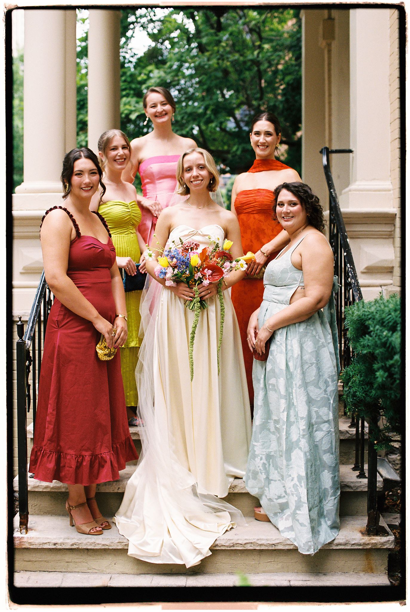 Colorful bridal party on the steps of The Fitzgerald. Film photograph.